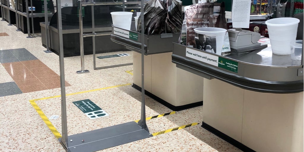 Social distancing floor stickers at store checkout area