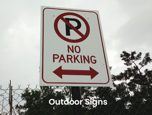 Outdoor signage example showing a no parking sign with arrows indicating a restricted area