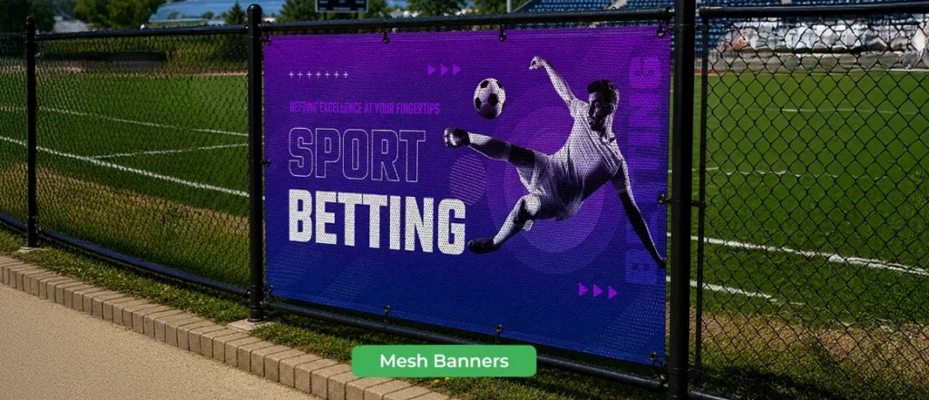 Mesh banner displayed on a sports field fence