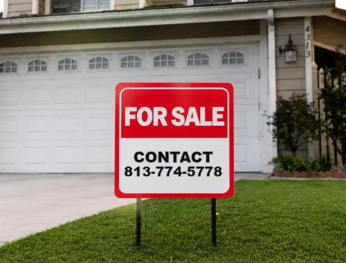 Custom for sale yard sign displayed on the front lawn of a residential property
