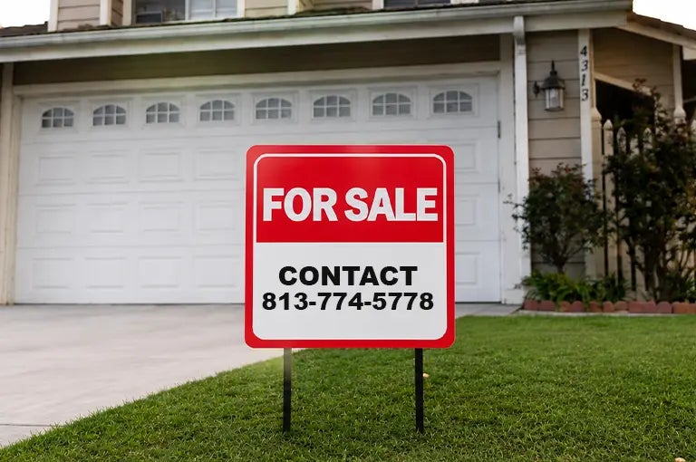 Custom for sale yard sign displayed on the front lawn of a residential property